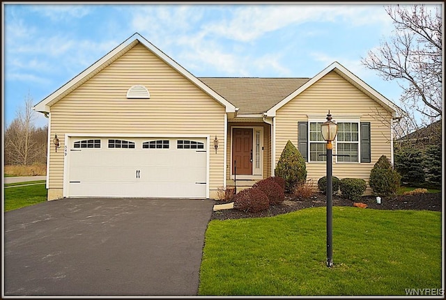 single story home with an attached garage, a front yard, and aphalt driveway