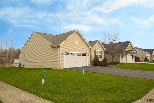 traditional home with an attached garage, driveway, and a front yard