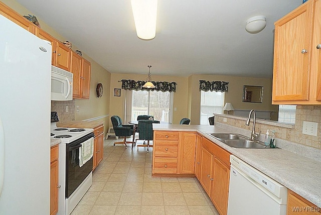 kitchen with tasteful backsplash, a sink, white appliances, light countertops, and a peninsula