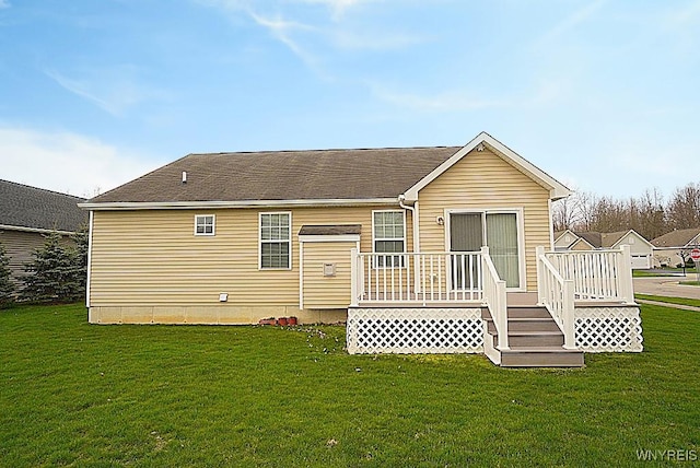 back of property with a lawn and a wooden deck