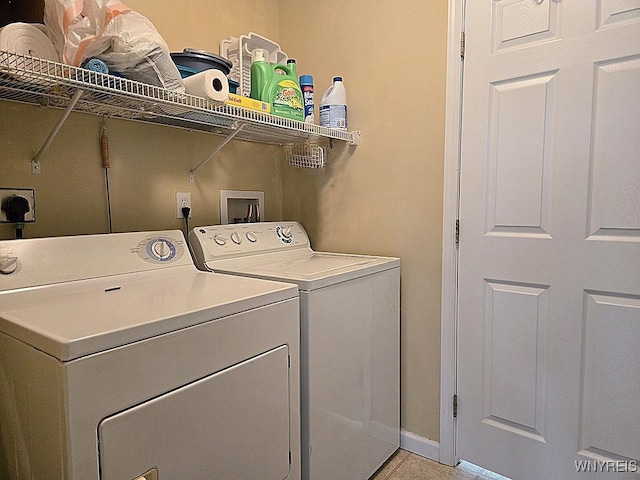 laundry room with washer and clothes dryer, baseboards, and laundry area