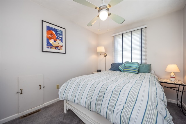carpeted bedroom featuring baseboards, a ceiling fan, and visible vents