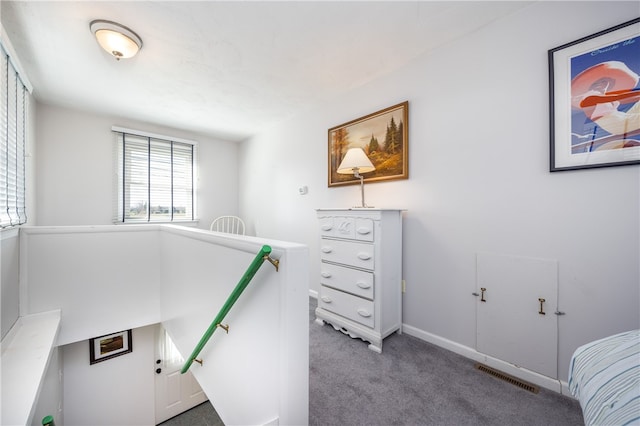 bedroom featuring baseboards, visible vents, and carpet