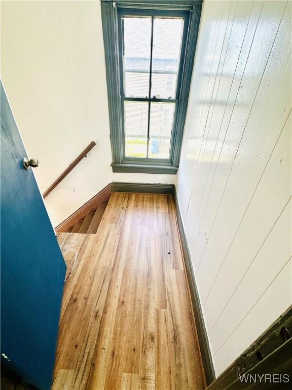 empty room with a wealth of natural light and wood finished floors