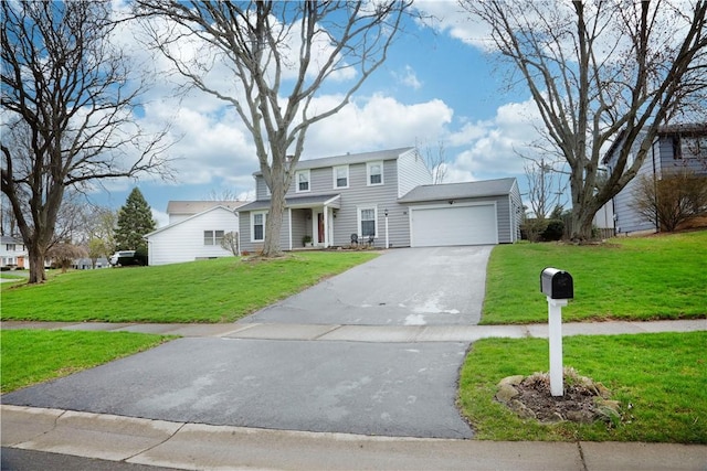 traditional-style home featuring a garage, driveway, and a front yard