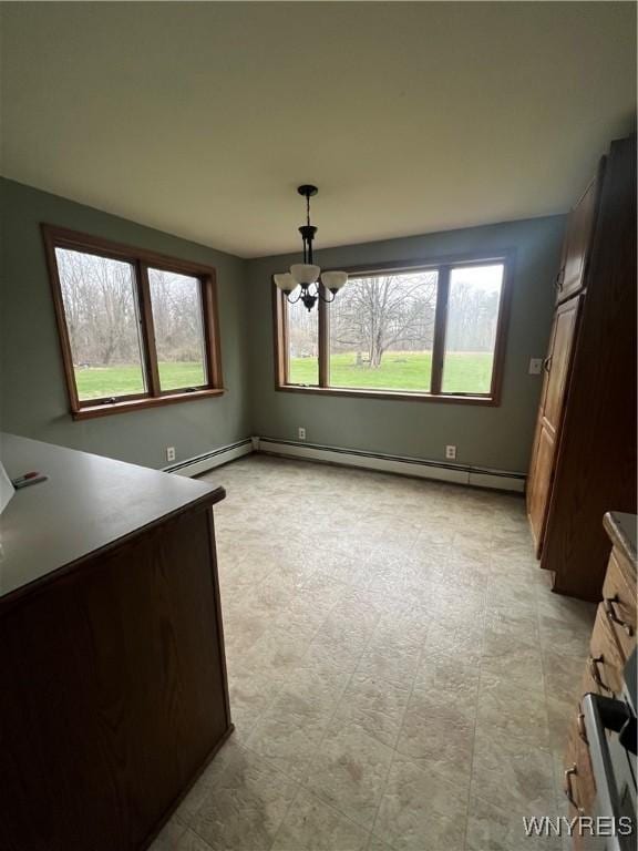 unfurnished dining area featuring a baseboard radiator and a notable chandelier
