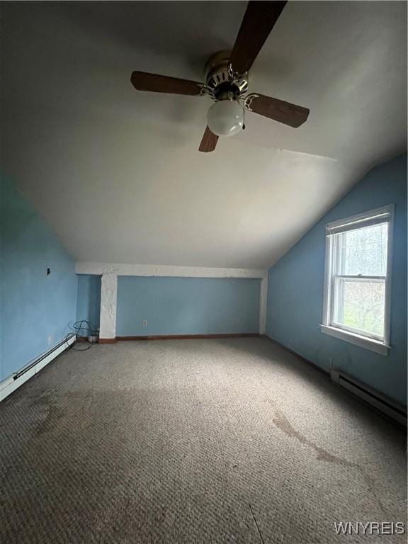 additional living space featuring ceiling fan, vaulted ceiling, carpet, and baseboard heating