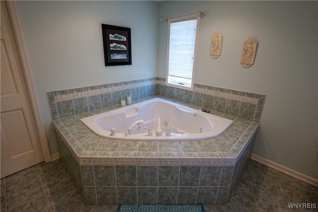 bathroom featuring a tub with jets and tile patterned flooring