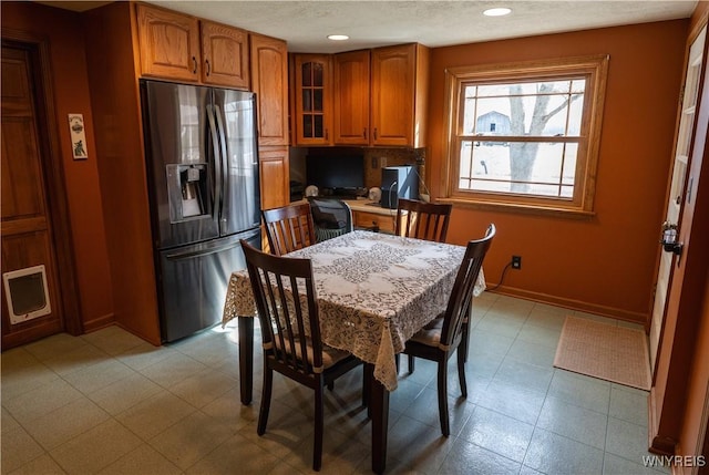 dining room with recessed lighting and baseboards