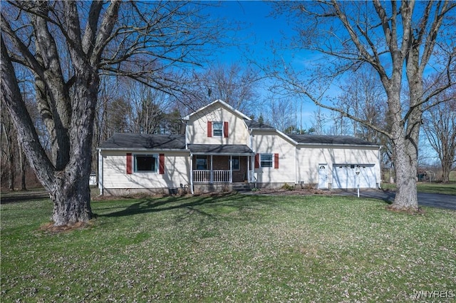 traditional home with driveway, a porch, a front lawn, and a garage