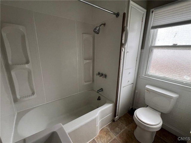 bathroom featuring shower / bath combination and toilet