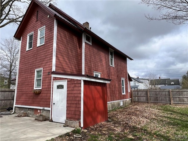 back of house featuring fence