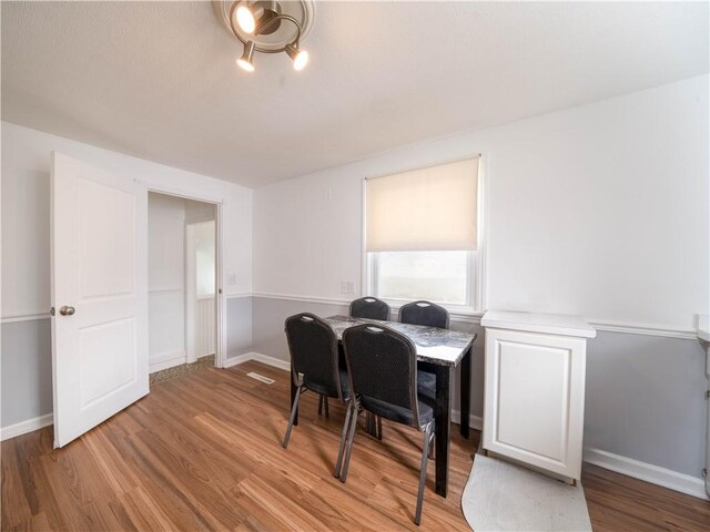 dining area featuring baseboards and wood finished floors