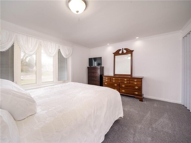 carpeted bedroom featuring baseboards and ornamental molding