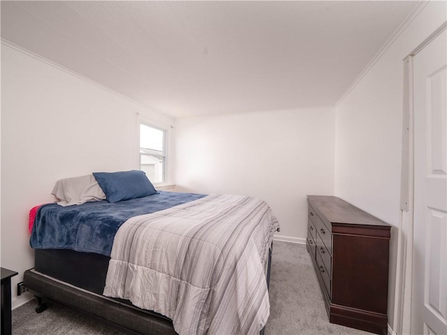 carpeted bedroom featuring baseboards and ornamental molding