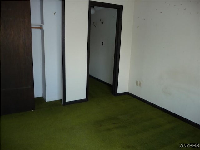 unfurnished bedroom featuring carpet floors, a closet, and baseboards