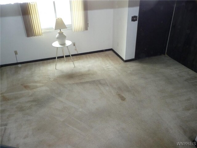 empty room with baseboards and carpet floors