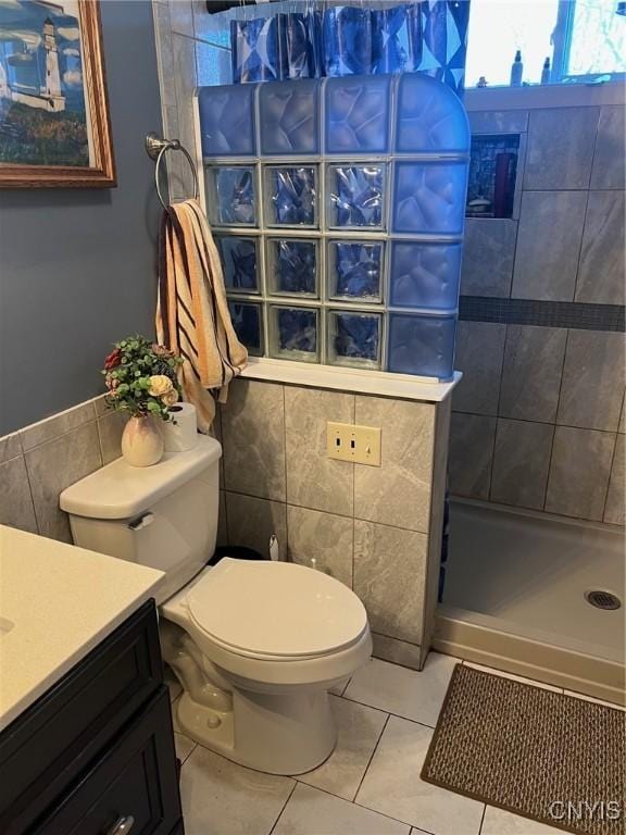 330 Hacadam Rd, Frankfort, NY 13456 - bathroom with tile walls, tiled shower, toilet, tile patterned floors, and vanity