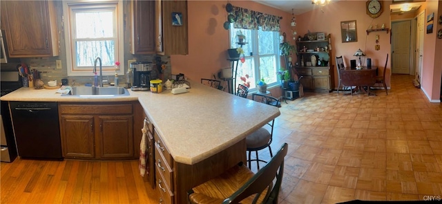 330 Hacadam Rd, Frankfort, NY 13456 - kitchen featuring a sink, light countertops, dishwasher, a kitchen bar, and a peninsula