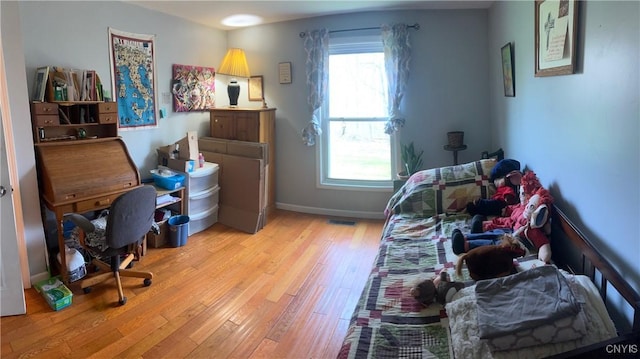 330 Hacadam Rd, Frankfort, NY 13456 - bedroom featuring multiple windows, light wood finished floors, and baseboards