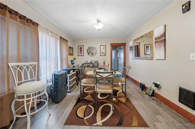 dining room with visible vents, wood finished floors, and baseboards