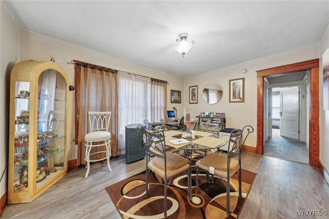 dining space with a healthy amount of sunlight, baseboards, and light wood-style floors