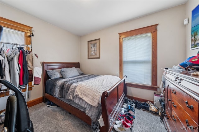 bedroom with baseboards and multiple windows