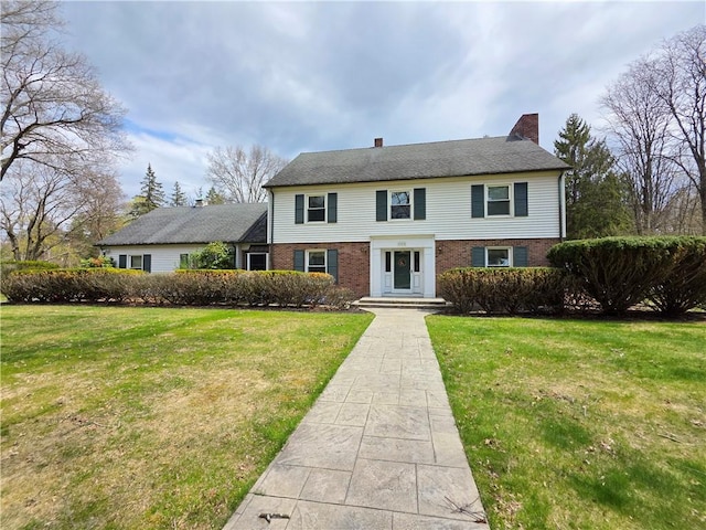 658 Cornell Rd, Elmira-City, NY 14905 - colonial inspired home with a chimney, brick siding, and a front yard