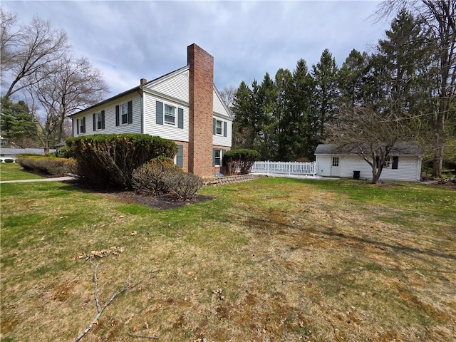 658 Cornell Rd, Elmira-City, NY 14905 - view of property exterior featuring a chimney, fence, and a yard