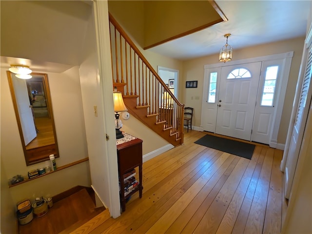 658 Cornell Rd, Elmira-City, NY 14905 - entryway featuring light wood-type flooring, a chandelier, baseboards, and stairs