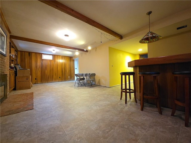 658 Cornell Rd, Elmira-City, NY 14905 - finished basement featuring wood walls, a dry bar, a brick fireplace, and baseboards