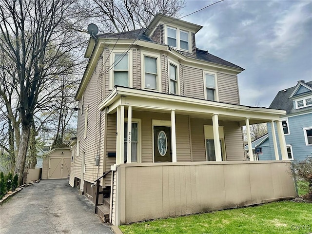 215 W Ostrander Ave, Syracuse, NY 13205 - american foursquare style home featuring a storage unit, driveway, a porch, a garage, and an outdoor structure