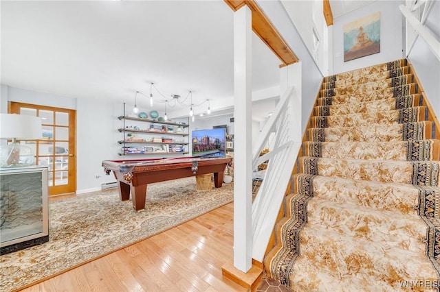 6317 Tonawanda Creek Rd, Lockport-Town, NY 14094 - stairs with a baseboard heating unit, wood-type flooring, baseboards, and pool table