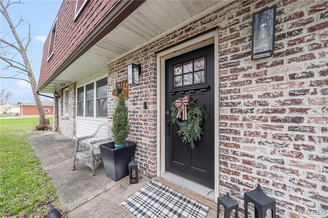 6317 Tonawanda Creek Rd, Lockport-Town, NY 14094 - view of exterior entry featuring a porch and brick siding