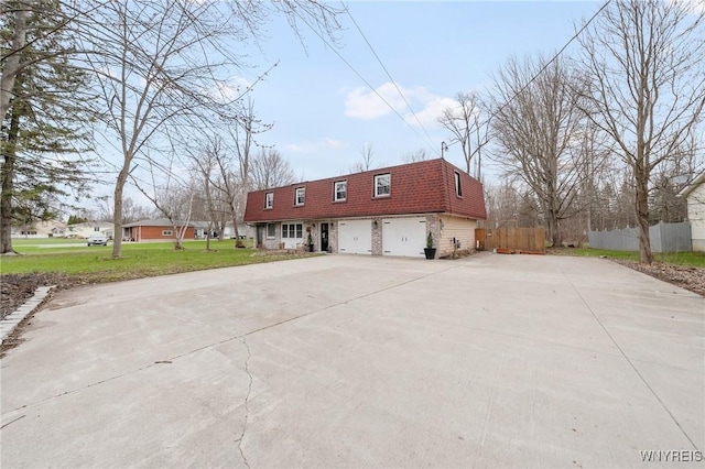 6317 Tonawanda Creek Rd, Lockport-Town, NY 14094 - view of front of house with a garage, driveway, mansard roof, fence, and a front yard