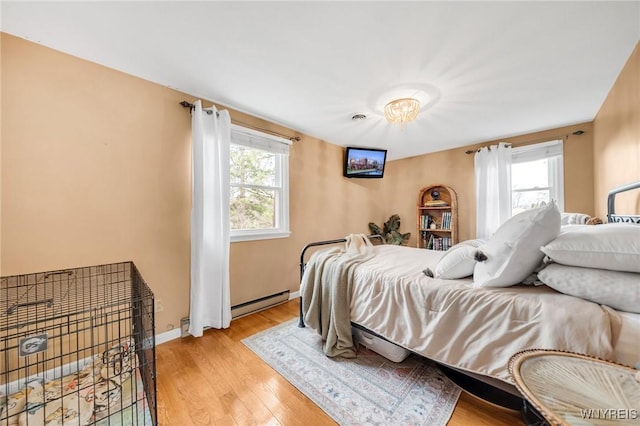 6317 Tonawanda Creek Rd, Lockport-Town, NY 14094 - bedroom with light wood-style floors, baseboards, and baseboard heating