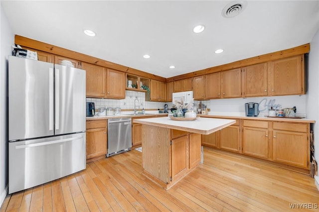 6317 Tonawanda Creek Rd, Lockport-Town, NY 14094 - kitchen with a sink, stainless steel appliances, light countertops, visible vents, and a kitchen island