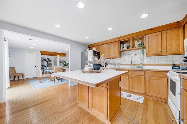 6317 Tonawanda Creek Rd, Lockport-Town, NY 14094 - kitchen featuring a center island, white electric range oven, a sink, freestanding refrigerator, and light countertops