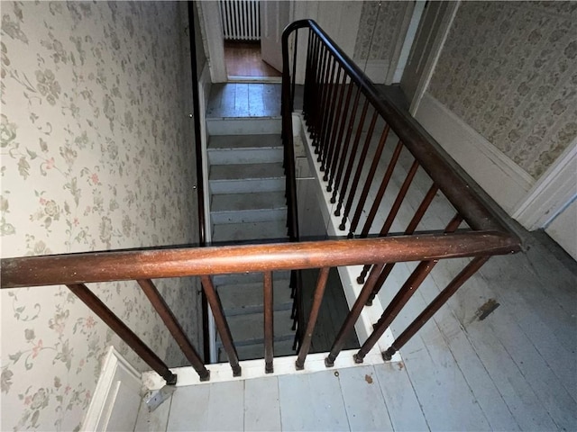 staircase featuring wallpapered walls