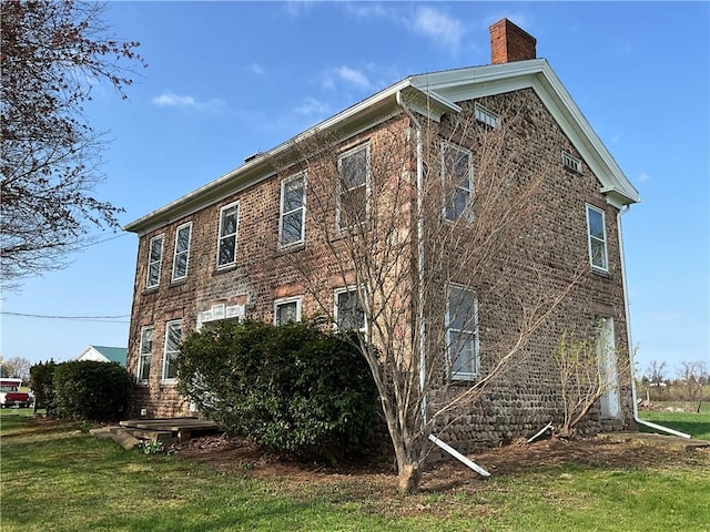 view of side of home featuring a chimney