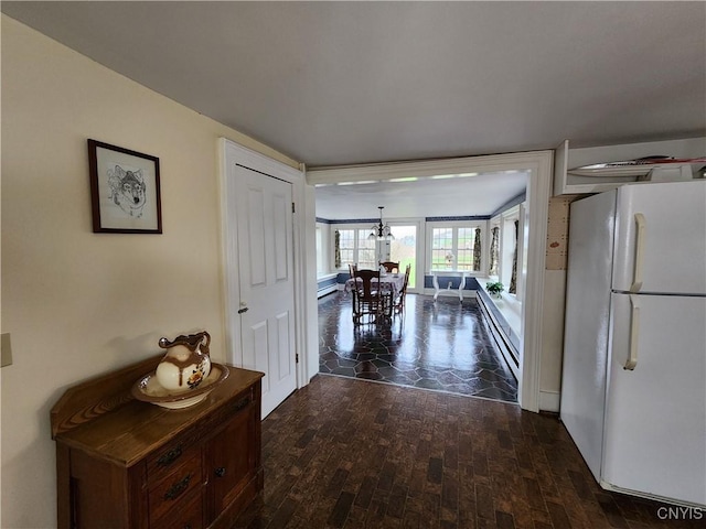 hallway featuring dark wood-style floors and baseboard heating