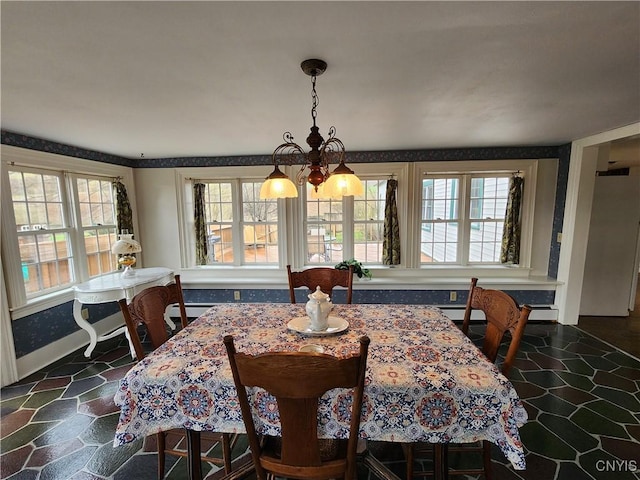 dining area with baseboards, a chandelier, and a baseboard radiator