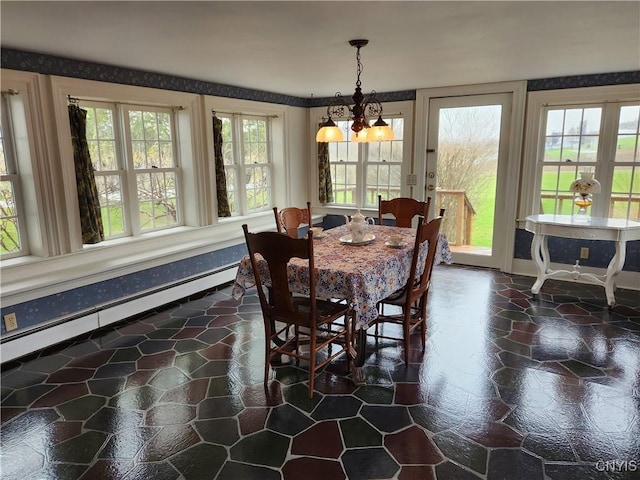 dining area featuring wallpapered walls, baseboard heating, baseboards, and an inviting chandelier