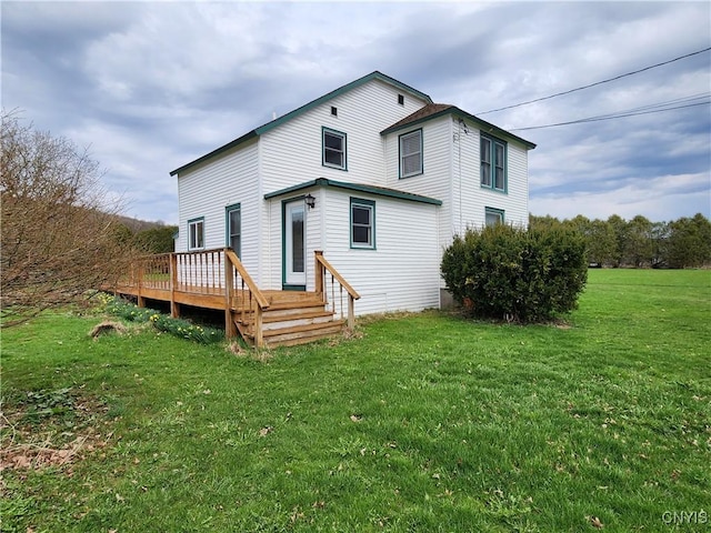 rear view of house with a lawn and a deck