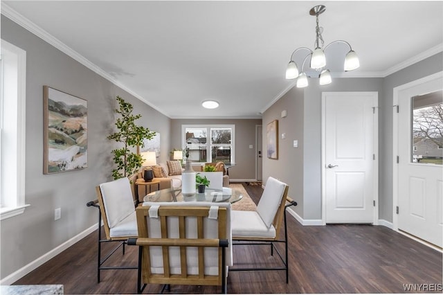 dining room featuring ornamental molding, baseboards, dark wood-style flooring, and an inviting chandelier