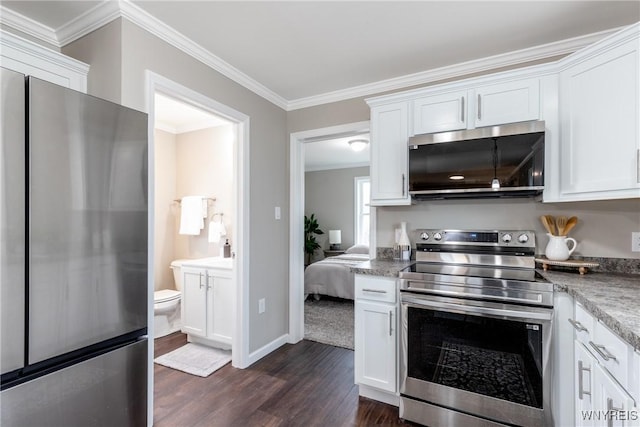 kitchen with white cabinets, crown molding, dark wood-style floors, and stainless steel appliances