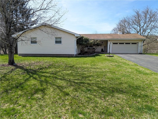 single story home featuring a garage, driveway, a chimney, and a front yard