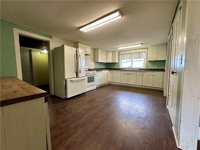 65 Union St, Starkey, NY 14837 - kitchen with a textured ceiling, white appliances, butcher block counters, white cabinets, and dark wood-type flooring