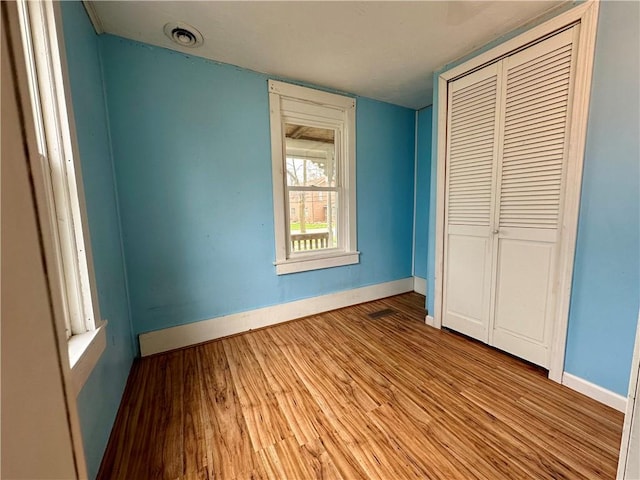 65 Union St, Starkey, NY 14837 - unfurnished bedroom with visible vents, wood finished floors, baseboards, and a closet
