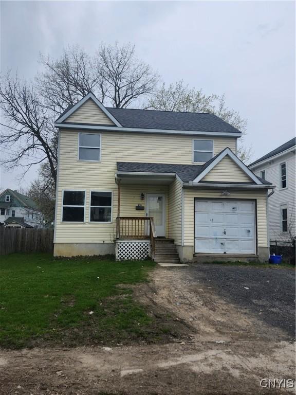 310 Merriman Ave, Syracuse, NY 13204 - view of front of home featuring fence, an attached garage, driveway, roof with shingles, and a front yard